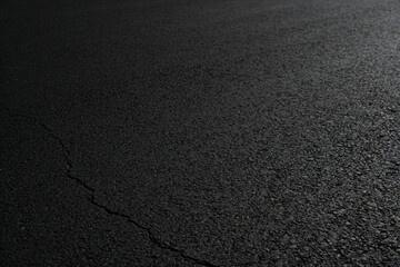 Obraz premium Close-up of Cracked Asphalt Road Surface