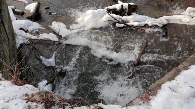A strong flow of wastewater from a large drainpipe