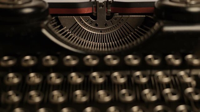 Close up of vintage black typewriter with round keys and red black ribbon for retro writing experience