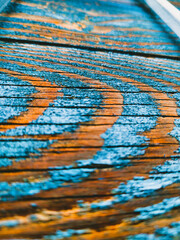 Obraz premium Vertical Macro Texture of Weathered Wood with Peeling Blue Paint, Abstract Organic Grain Pattern on Distressed Timber Surface, Natural Aged Wood Background for Rustic Design and Creative Aesthetics.