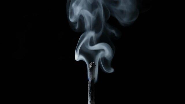 a slow‑motion macro view of a black matchstick releasing white smoke against a dark backdrop, captured in high‑resolution close‑up