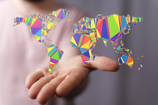 Abstract low poly world map on a hand, representing global connectivity, diversity and communication. Perfect for inter