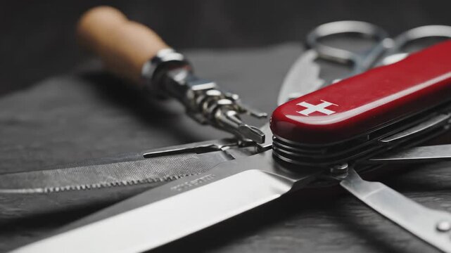 Close up of a red swiss army knife with tools.