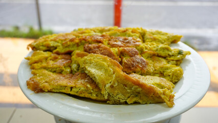 A typical Padang restaurant omelette. The omelette is displayed in the restaurant's glass display case to attract customers.