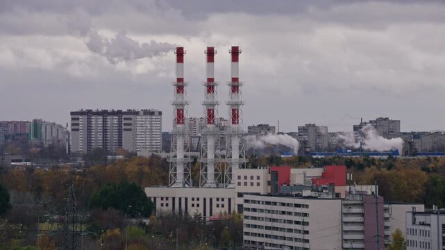 Industrial Chimneys With Smoke Above Residential Buildings