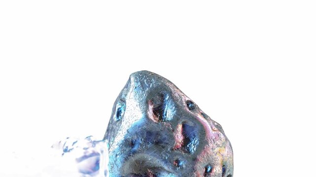 Close up view of metallic asteroid surface with blue and pink iridescent glow and detailed craters isolated on white forming a futuristic abstract texture