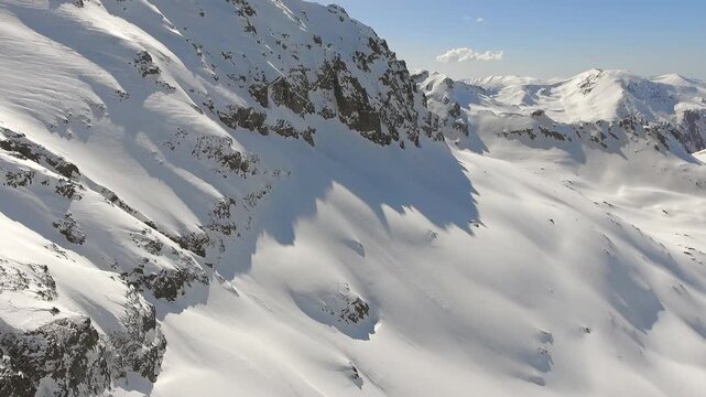 Aerial perspective shows Kackar peaks, snowbound ridges across North Anatolia, Black Sea Turkey. Overhead panorama reveals icy summits and glacier carved slopes near Rize, Pontic Alps wilderness.