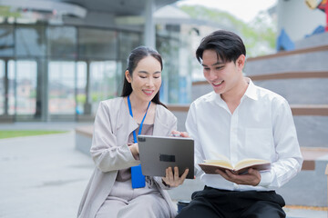 Obraz premium A cheerful businesswoman stands in her office, using a digital tablet to work on a financial project.