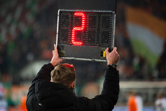 Technical referee shows 2 minutes added time during the football match.