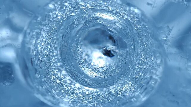 Frozen abstract ice crystals with water, blue texture background. Water and ice.