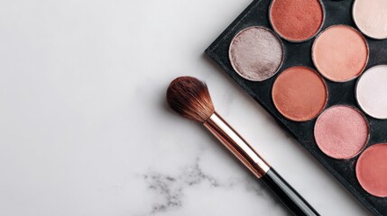 Makeup palette and brush on marble background