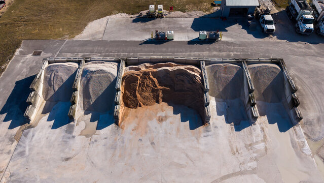 aerial view of  storage bins with industrial aggregate yard, gravel storage bins, sand piles and crushed stone bins used for the construction industry


