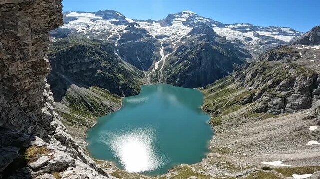 Scenic landscape of alpine lake and snow-capped mountains on sunny day. Travel, nature, landscape, mountain, lake, alpine, snow.