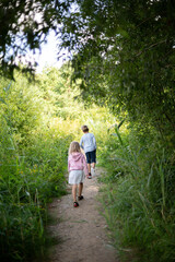 Obraz premium Children hiking on forest trail, family outdoor adventure