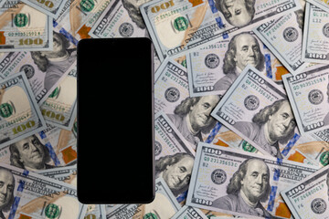 Smartphone with Black Screen on a Background of One Hundred US Dollar Bills