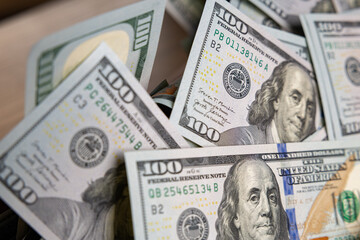 Background of Scattered One Hundred US Dollar Bills with Blue Security Ribbons