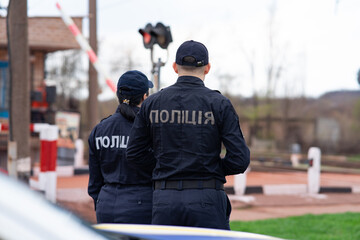 Fototapeta premium Ukrainian Police Officers Monitoring a Railway Crossing during Patrol