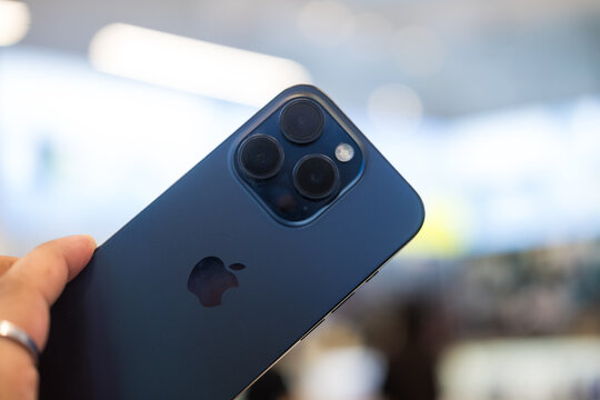 Samut Prakan, Thailand - February 22, 2023 : Male hand holding new iPhone 15 Pro Max blue Titanium.