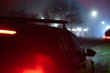 Obraz premium Police Patrol Car with Flashing Emergency Lights at Night on Road