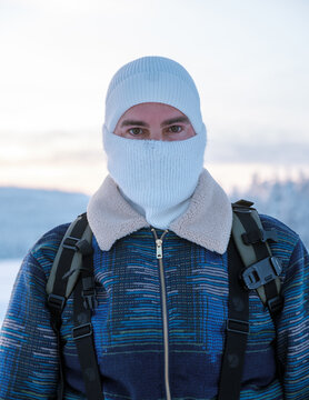 Explore Akaslompolo Village in the heart of Lapland, Finland. A traveler dressed warmly enjoys the serene snowy landscape and peaceful atmosphere, capturing the essence of a perfect winter getaway.