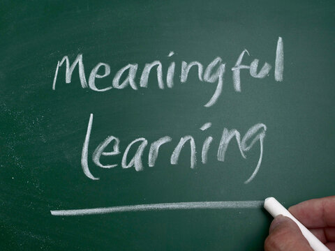 Meaningful Learning, handwritten on a green chalkboard, educational concept representing deep understanding