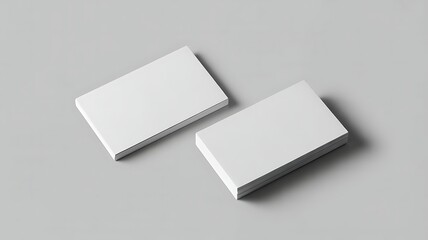 Two stacks of blank white business cards on a gray surface for corporate identity and professional networking purposes