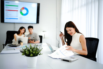 Fototapeta premium Female leader, manager or CEO with a smile, mission and vision in the office and her team in the background. Leadership, management and success with a woman boss and corporate business people at work