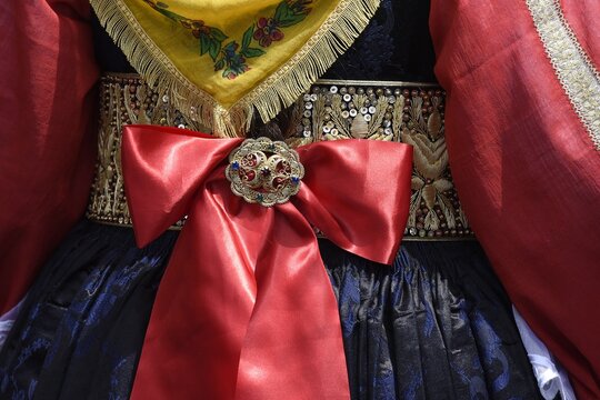 Traditional female Corfiot costume skirt embroidered with a satin ribbon and a handcrafted golden broch as seen during the May 21st National Holiday Parade in the Old Town of Corfu island, Greece.