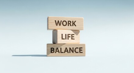Wooden blocks stacked, spelling "Work Life Balance" against a light blue backdrop