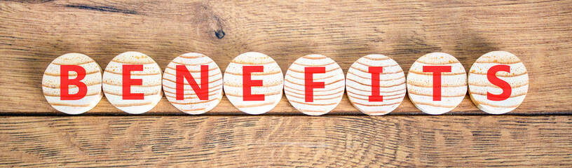 Obraz premium Benefits word symbol. Concept word Benefits on beautiful wooden circles. Beautiful wooden background. Business support help benefits word concept. Copy space.