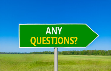 Any questions symbol. Concept words Any questions on beautiful green road sign. Beautiful blue sky green grass field background. Business and Any questions Q and A concept, copy space.