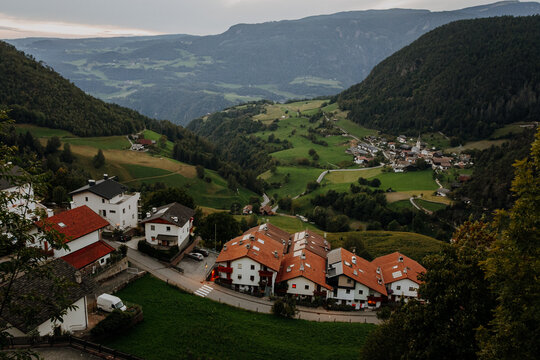 Scenic Aerial View of Castelrotto Village in South Tyrol &ndash; Traditional Alpine Architecture and Lush Green Mountain Valley in the Dolomites