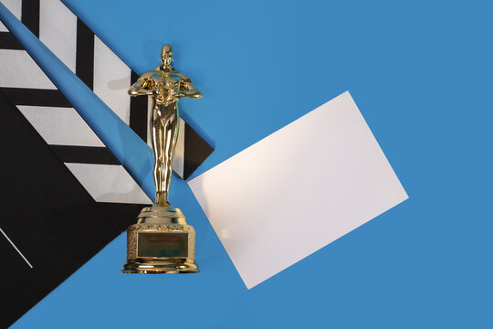 Oscar award with card on blue background, filmmaking recognition and success, cinema celebration and achievement,Moscow, Russia, January 21, 2025