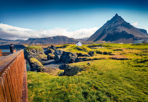 Gorgeous summer view of small fishing village at the foot of Mt. Stapafell - Arnarstapi or Stapi. Perfect morning scene of Icelandic countryside. Traveling concept background.