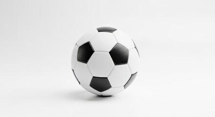 Naklejka premium A classic black and white soccer ball spins gracefully on a smooth surface, capturing the essence of the game in a minimalistic setting