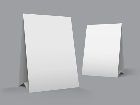 Table top advertising tent template. White blank paper banner stand for counter display. Realistic mockup. Vector mockup of a tabletop advertising graphic card for a cafe. Blank mockup on a table.
