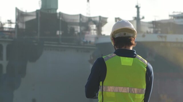 Maritime logistics superintendent analyzing digital freight parameters via laptop. Professional port operations supervisor managing terminal infrastructure efficiency.