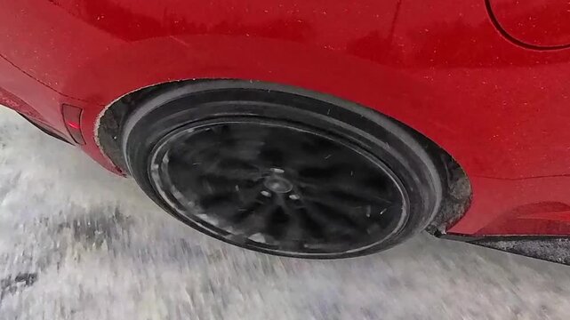 Close-up of a sports car wheel during drifting. 