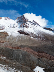 Obraz premium Aerial view of Mount Kazbek with exposed rocky terrain and glacial formations in the Greater Caucasus, Georgia