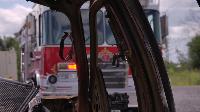 Fire truck at the scene of a burned out car