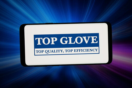 Stuttgart, Germany - 02-19-2026: In this photo illustration, the logo of Malaysian company Top Glove Corporation Bhd is displayed on a smartphone in front of abstract background on computer screen.