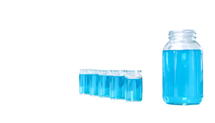 Small vials & a large jar filled with bright blue liquid, on a black background