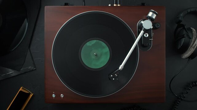 Vinyl Record Spinning in Slow Motion on a Stylish Turntable Standing on a Table - Top View