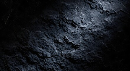 Fototapeta premium Dark textured slate background with subtle light highlights and deep shadows, abstract natural surface.