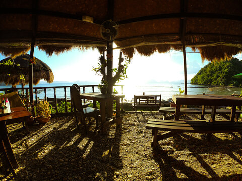 Beautiful sunset at Las Cabanas Beach, seen by the beach bar made interely of wood with a very rustic aspect, El Nido, Palawan, Philippines.