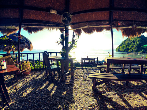 Beautiful sunset at Las Cabanas Beach, seen by the beach bar made interely of wood with a very rustic aspect, El Nido, Palawan, Philippines.