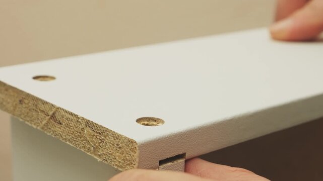 Furniture assembly from the laundry room using screws and screwdrivers. The middle plan.