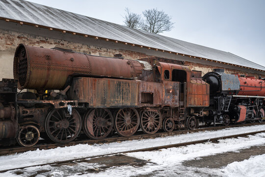 Rusty Abandoned Steam Locomotive in Winter Railway Yard