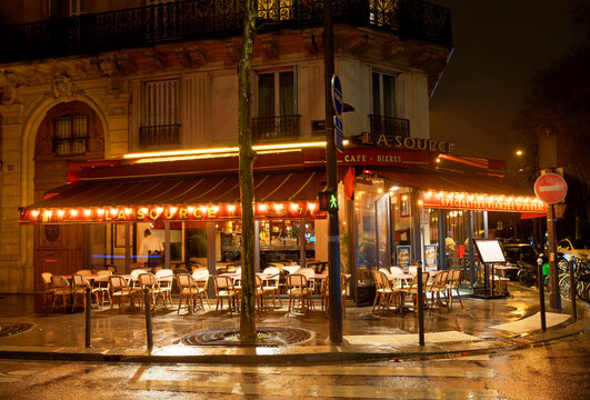 La Source is traditional French cafe at rainy night. It located in the 7th district of Paris,  La Source is traditional French cafe at rainy night.