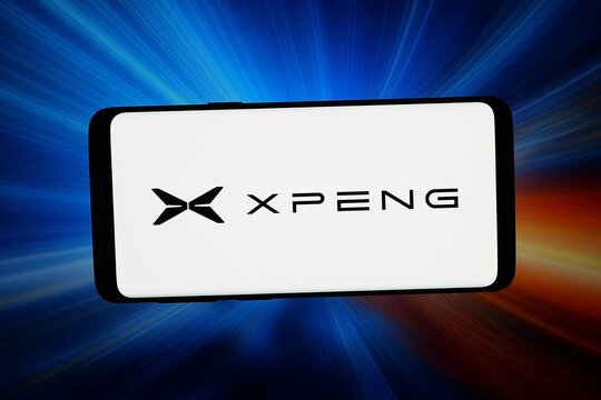 Stuttgart, Germany - 02-19-2026: In this photo illustration, the logo of Guangzhou Xiaopeng Motors Technology (XPeng) is displayed on a smartphone in front of abstract background on computer screen.